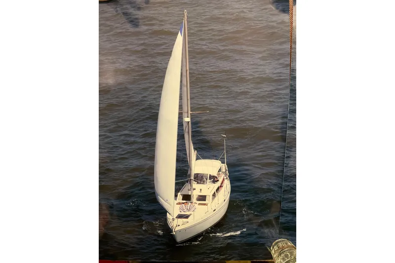 The Image of 1973 Columbia Center Cockpit sailboat navigating calm waters with full sails. - 1