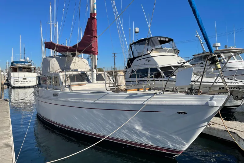 Slide: The Image of 1973 Columbia Center Cockpit sailboat docked at marina under clear blue sky. - 10