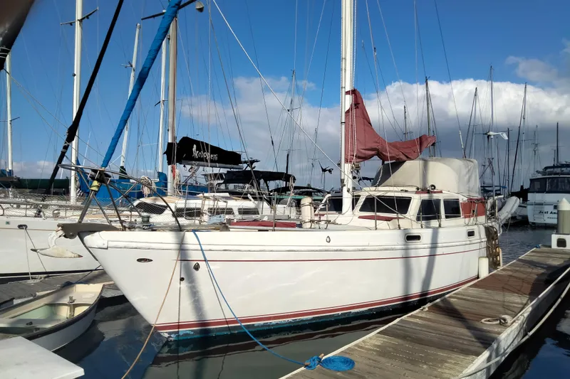 Slide: The Image of 1973 Columbia Center Cockpit sailboat docked at marina under blue sky. - 11
