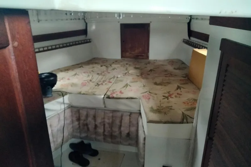 Slide: The Image of Interior cabin of a 1973 Columbia Center Cockpit sailboat with floral-patterned bedding. - 3