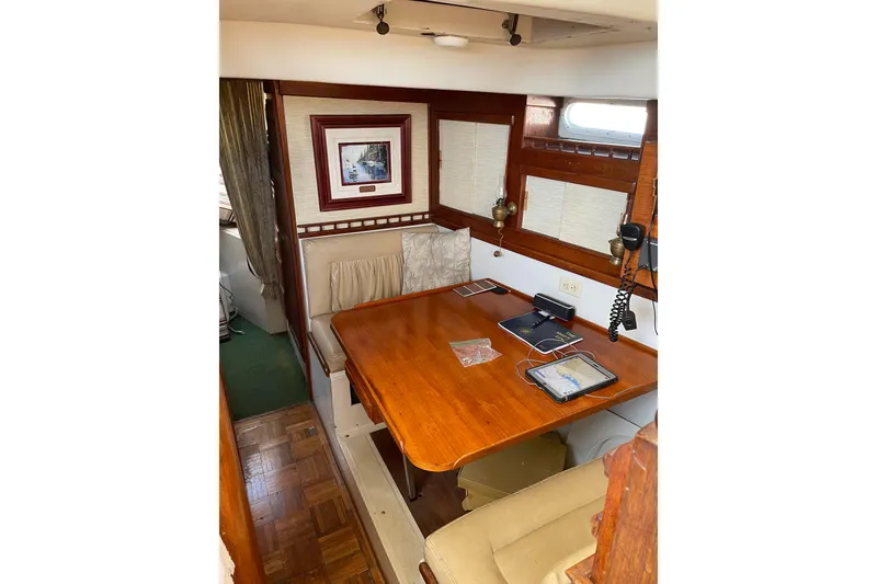 Slide: The Image of 1973 Columbia Center Cockpit interior with wooden table, seating, and nautical decor. - 4