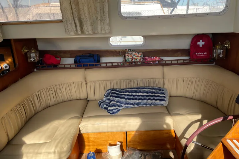 Slide: The Image of 1973 Columbia Center Cockpit interior with beige seating, safety kit, and nautical decor. - 5