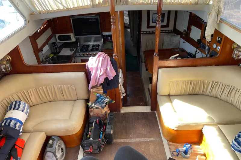 Slide: The Image of Interior of a 1973 Columbia Center Cockpit sailboat with seating and kitchen area. - 7