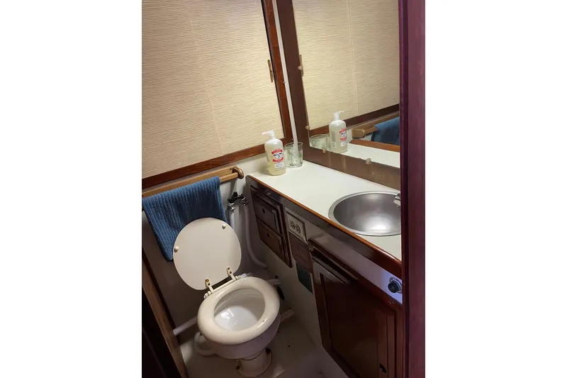 Slide: The Image of 1973 Columbia Center Cockpit bathroom with sink, toilet, and mirror. - 9