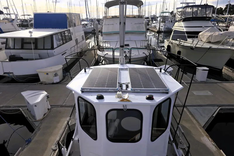 Slide: The Image of Custom 2016 25 Tug boat docked at marina with solar panels on roof. - 11