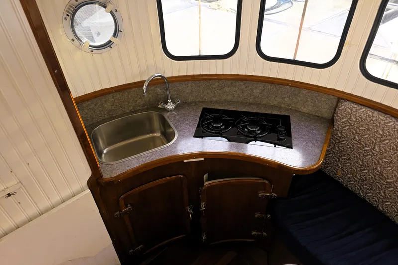 Slide: The Image of Compact kitchen area in a 2016 Custom 25 Tug boat with sink and stove. - 18