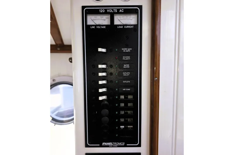 Slide: The Image of Electrical panel on a 2016 Custom 25 Tug boat, featuring various switches and indicators. - 23