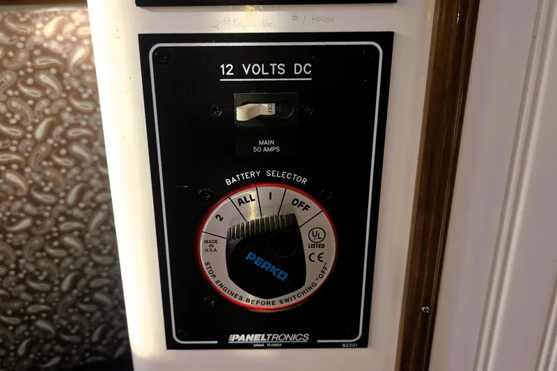 Slide: The Image of 2016 Custom 25 Tug battery selector panel with 12 volts DC and main switch. - 25