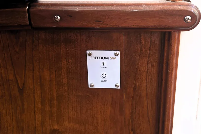 Slide: The Image of Wooden panel with "FREEDOM SW" control switch on a 2016 Custom 25 Tug. - 26