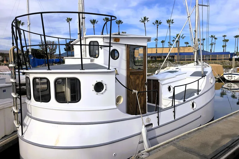 Slide: The Image of Custom 2016 model 25 Tug boat docked at marina with palm trees in background. - 3