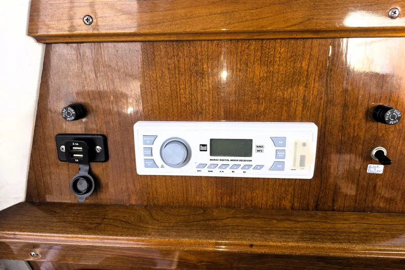 Slide: The Image of Wooden dashboard with digital media receiver and USB ports on a 2016 Custom 25 Tug. - 31