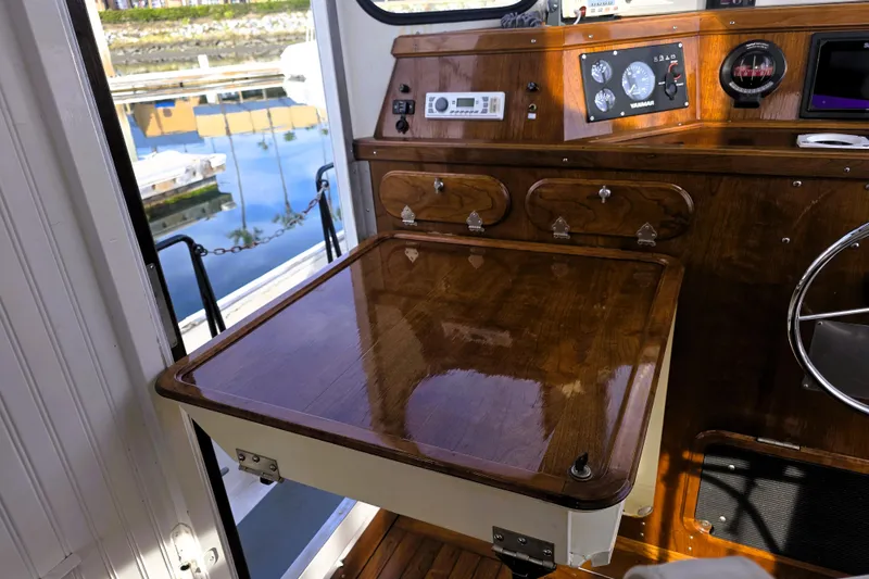 Slide: The Image of Interior of 2016 Custom 25 Tug with polished wood table and control panel. - 33