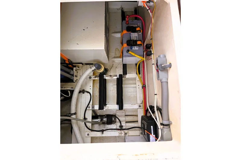 Slide: The Image of Engine compartment of a 2016 Custom 25 Tug with visible wiring and hoses. - 36