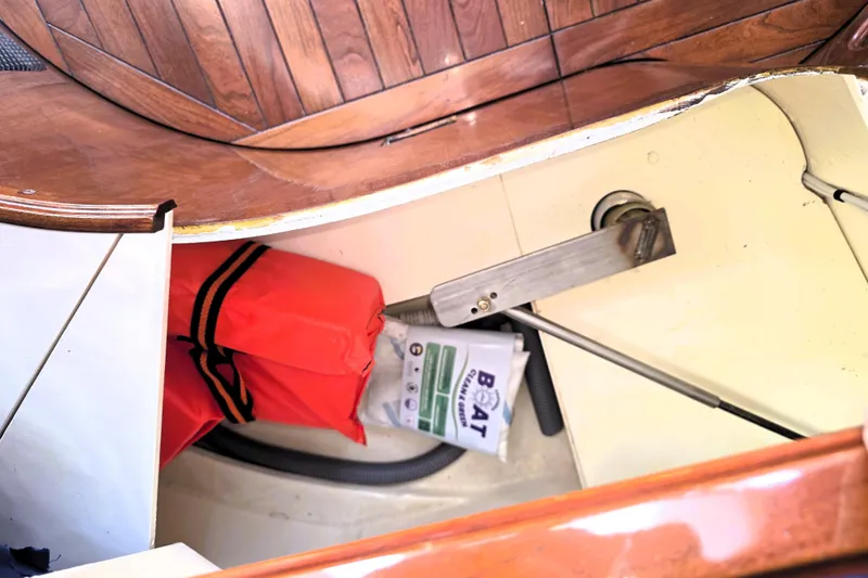 Slide: The Image of Storage compartment in a 2016 Custom 25 Tug boat with life jacket and cleaning supplies. - 39