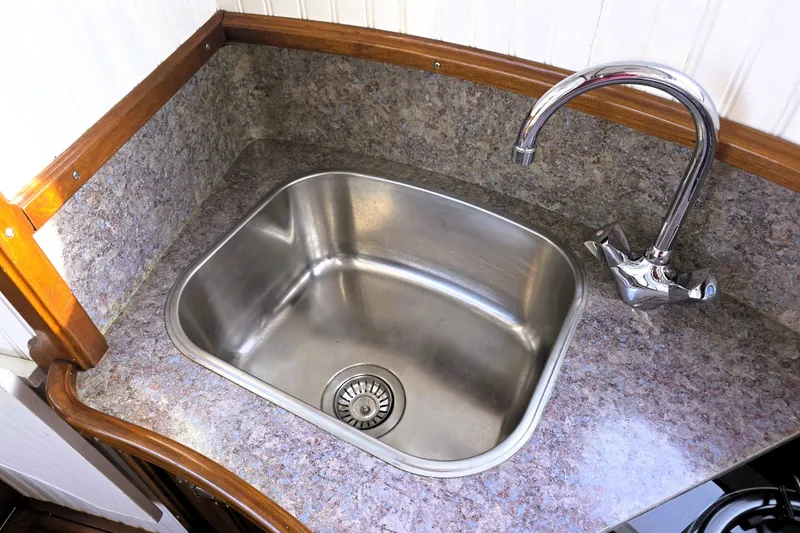 Slide: The Image of Stainless steel sink with chrome faucet in 2016 Custom 25 Tug boat kitchen. - 42