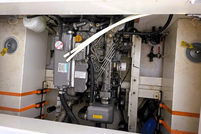 Slide: The Image of Engine compartment of a 2016 Custom 25 Tug, showcasing mechanical components and wiring. - 43