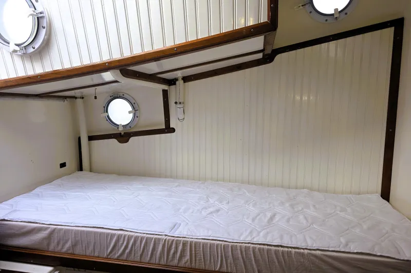 Slide: The Image of Cozy cabin interior of 2016 Custom 25 Tug with portholes and bed. - 45