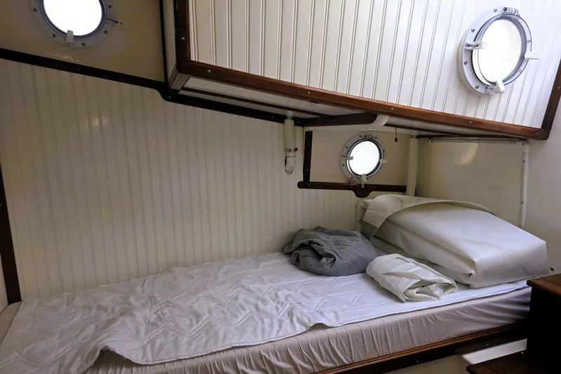 Slide: The Image of Cozy cabin interior of 2016 Custom 25 Tug with portholes and bed. - 46