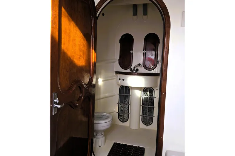 Slide: The Image of 2016 Custom 25 Tug bathroom interior with wooden door and compact fixtures. - 48