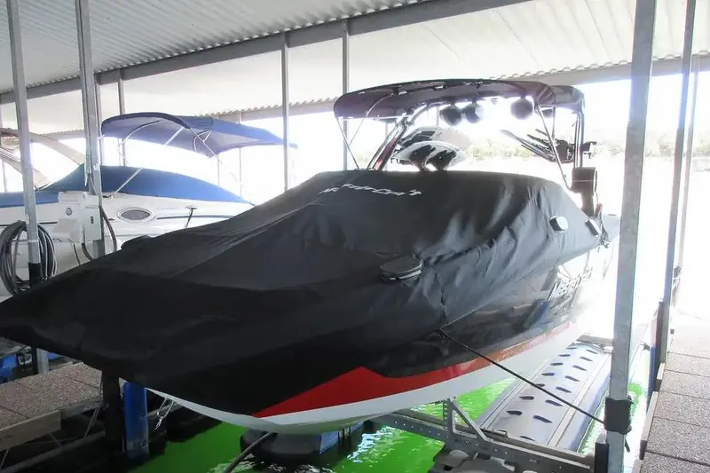 Slide: The Image of 2022 MasterCraft X24 boat covered and docked in a marina. - 3