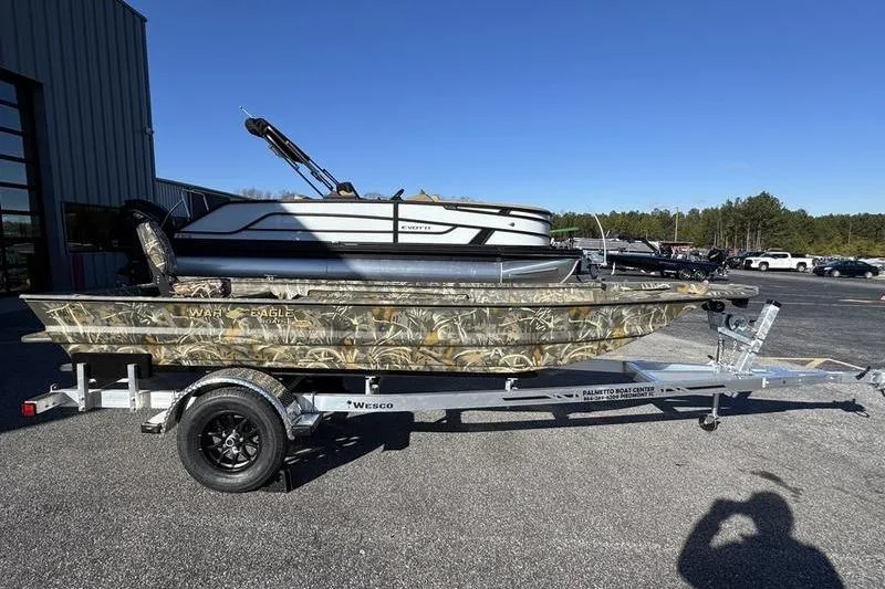 Slide: The Image of 2026 War Eagle 648LDV boat on trailer, camouflage design, parked outdoors. - 4