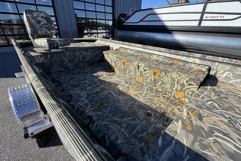 Slide: The Image of 2026 War Eagle 648LDV boat interior with camouflage seating and flooring design. - 5