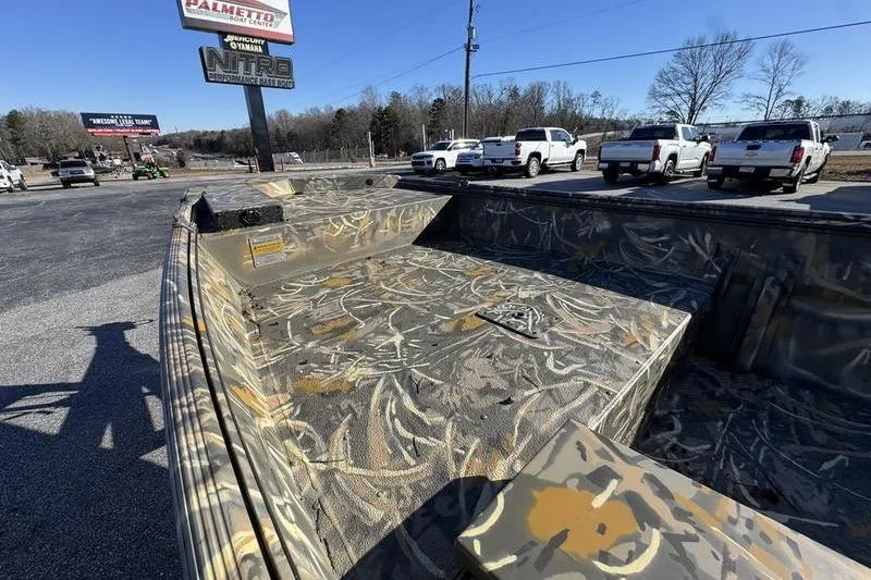 Slide: The Image of 2026 War Eagle 648LDV boat with camouflage design in a parking lot setting. - 6