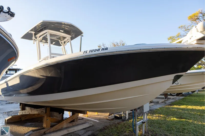The Image of 2016 Robalo 246 Cayman boat on display, elevated on wooden supports. - 0