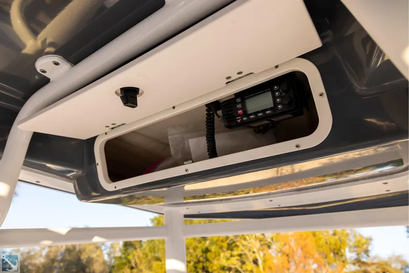 Slide: The Image of 2016 Robalo 246 Cayman boat console with radio equipment in storage compartment. - 11