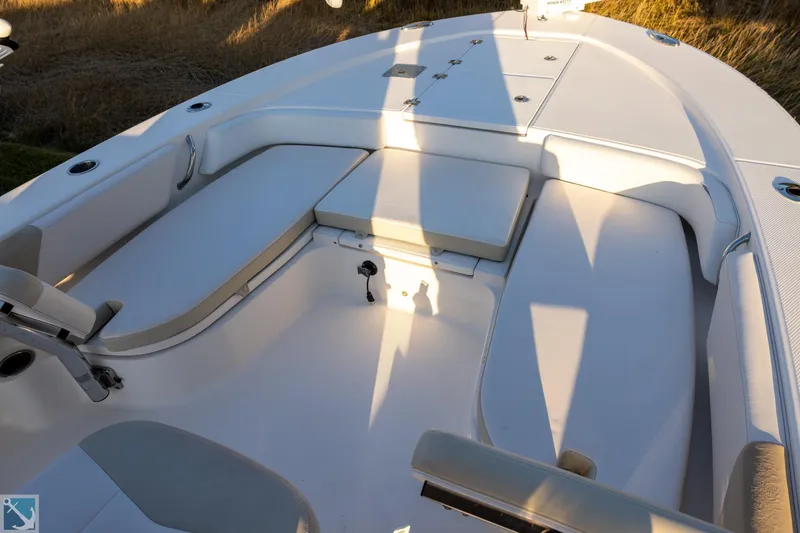 Slide: The Image of 2016 Robalo 246 Cayman boat interior with cushioned seating and storage compartments. - 15