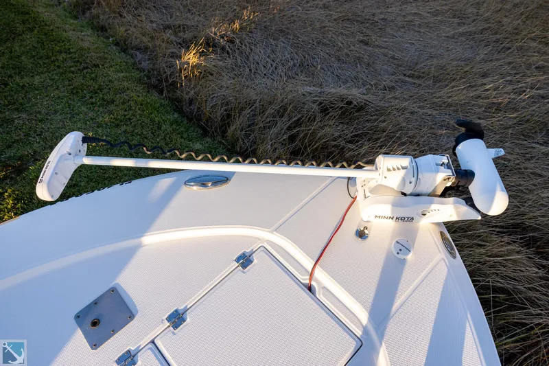 Slide: The Image of 2016 Robalo 246 Cayman boat with Minn Kota trolling motor on deck. - 16