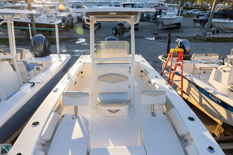 Slide: The Image of 2016 Robalo 246 Cayman boat interior, docked among other boats in a marina. - 17