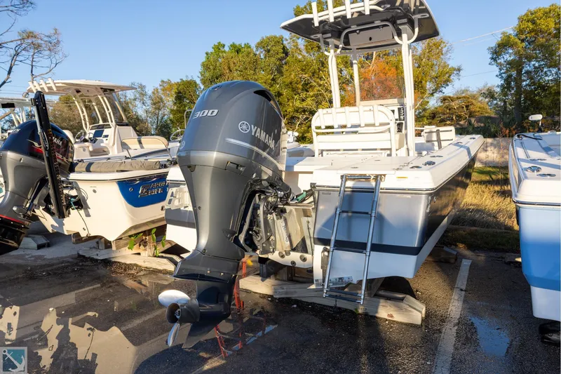 Slide: The Image of 2016 Robalo 246 Cayman boat with Yamaha 300 engine, parked outdoors. - 2