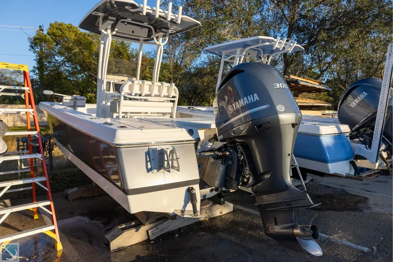 Slide: The Image of 2016 Robalo 246 Cayman boat with Yamaha 300 engine, parked outdoors. - 3