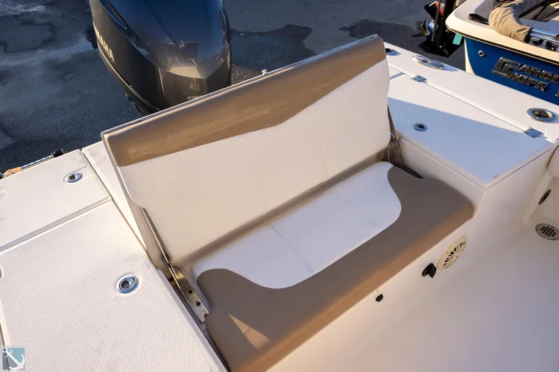 Slide: The Image of 2016 Robalo 246 Cayman boat seating area with beige and white upholstery. - 6