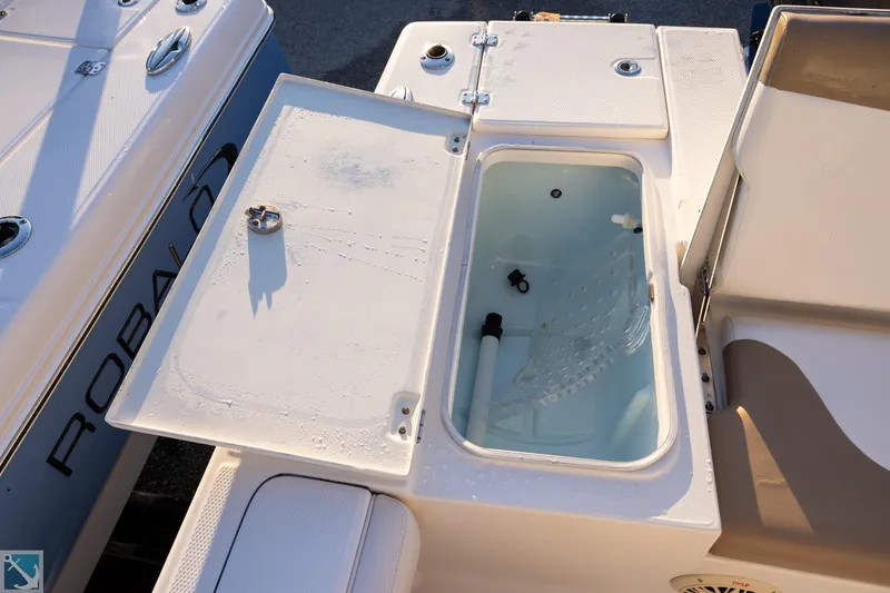 Slide: The Image of 2016 Robalo 246 Cayman boat with open storage compartment on deck. - 7