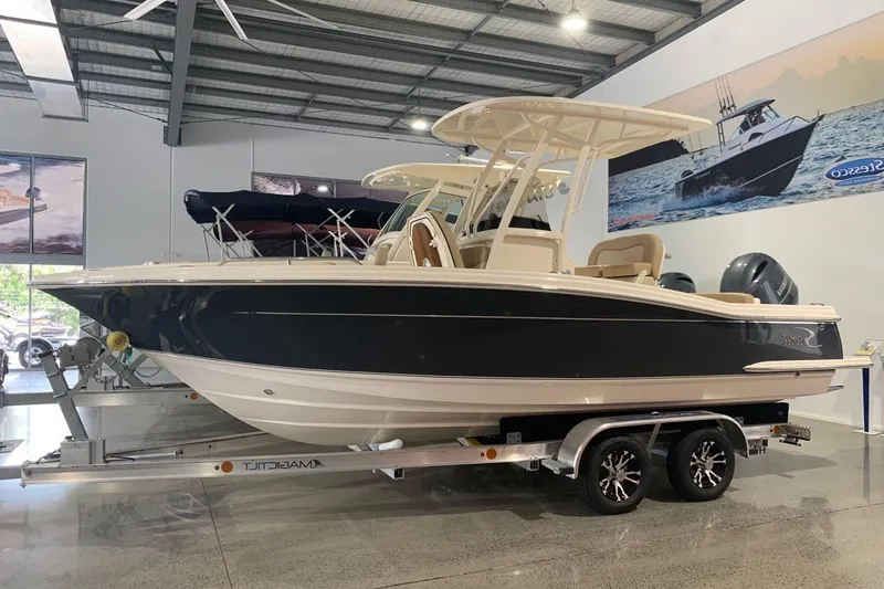 Slide: The Image of 2022 Scout 215 XSF boat on trailer in showroom, side view. - 5