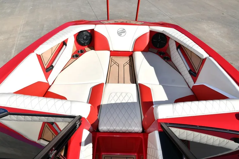 Slide: The Image of 2022 Tigé 24RZX boat interior with red and white seating, featuring diamond stitching. - 2