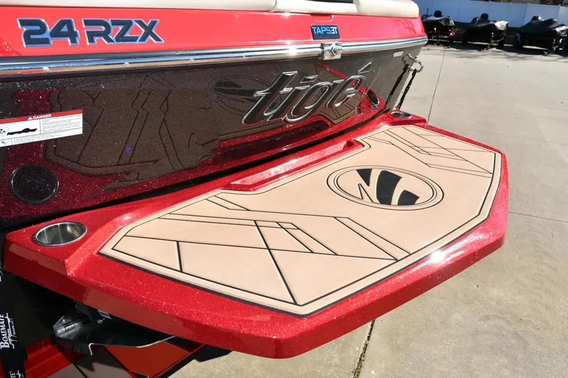 Slide: The Image of 2022 Tigé 24RZX boat with red and beige swim platform, showcasing sleek design. - 5