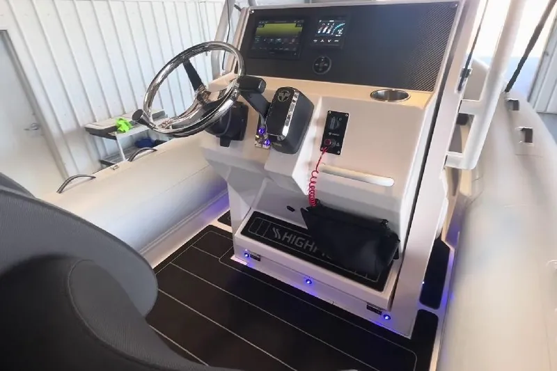 Slide: The Image of 2024 Highfield Sport 660 boat cockpit with modern steering and control panel. - 3