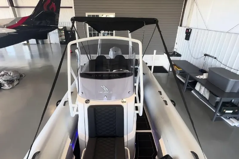 Slide: The Image of 2024 Highfield Sport 660 boat in a hangar, showcasing sleek design and modern features. - 4