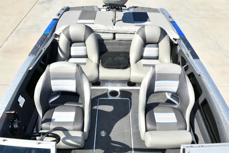 Slide: The Image of 2024 Ranger 212LS Reata boat interior with four gray and white seats. - 3