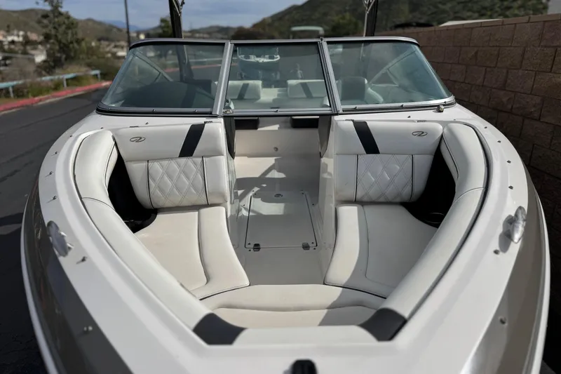 Slide: The Image of 2018 Regal 2100 Bowrider boat with spacious seating and sleek design. - 12