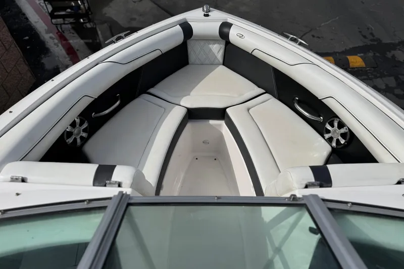 Slide: The Image of 2018 Regal 2100 Bowrider boat interior with white and black seating, overhead view. - 13