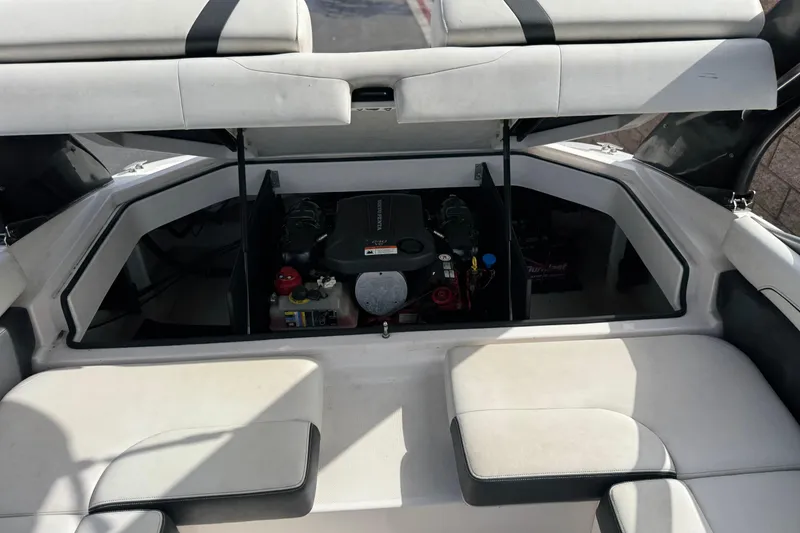 Slide: The Image of 2018 Regal 2100 Bowrider engine compartment with open seating and visible engine components. - 20