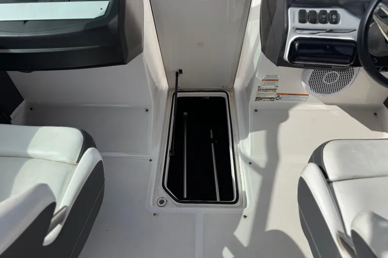 Slide: The Image of 2018 Regal 2100 Bowrider interior with open storage compartment and seating. - 23