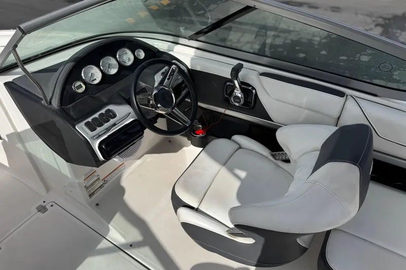 Slide: The Image of 2018 Regal 2100 Bowrider boat interior with steering wheel and dashboard controls. - 24