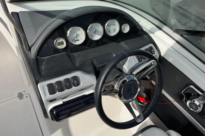 Slide: The Image of 2018 Regal 2100 Bowrider dashboard with steering wheel and gauges. - 26