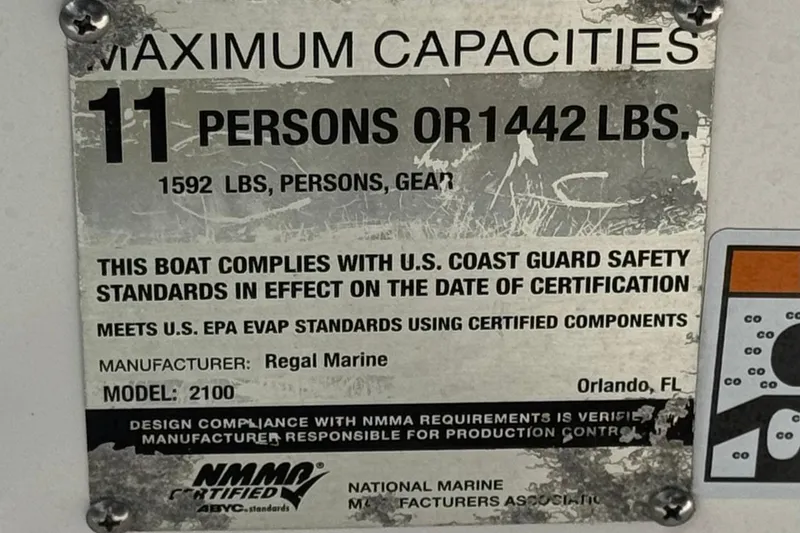 Slide: The Image of Capacity plate for 2018 Regal 2100 Bowrider, 11 persons or 1442 lbs, NMMA certified. - 29