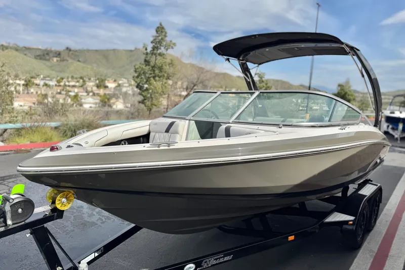 Slide: The Image of 2018 Regal 2100 Bowrider boat on trailer, scenic background, sunny day. - 3